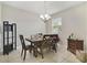Dining room featuring a wood table and chairs, chandelier, and neutral decor at 1209 Seburn Rd, Apopka, FL 32703