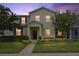 Two-story townhome with landscaping and nighttime lighting at 1209 Seburn Rd, Apopka, FL 32703