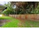 Backyard with wooden fence and lush green grass at 709 Del Rio Way, Kissimmee, FL 34758