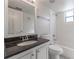Clean bathroom with granite countertop, white tile and bathtub at 709 Del Rio Way, Kissimmee, FL 34758