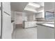 Modern kitchen with white cabinets, granite countertops, and tiled floors at 709 Del Rio Way, Kissimmee, FL 34758