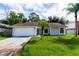 Charming single-story home with a two-car garage and well-maintained lawn at 709 Del Rio Way, Kissimmee, FL 34758