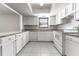 Updated kitchen featuring white cabinets and granite countertops at 709 Del Rio Way, Kissimmee, FL 34758