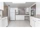 Clean kitchen with white cabinets, granite counters, and tile floors at 709 Del Rio Way, Kissimmee, FL 34758