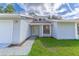 Newly renovated light blue house with a white door and well-maintained lawn at 709 Del Rio Way, Kissimmee, FL 34758