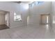 Open living area with high ceilings, tile floors, and kitchen views at 709 Del Rio Way, Kissimmee, FL 34758
