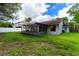 Spacious backyard with screened patio and grassy area at 709 Del Rio Way, Kissimmee, FL 34758