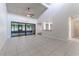 Bright living room with vaulted ceiling, tile floor, and sliding glass doors at 709 Del Rio Way, Kissimmee, FL 34758