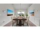 Elegant dining room with a stunning chandelier and large window overlooking the backyard at 4070 Island Lakes Dr, Winter Haven, FL 33881