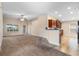 Open living room with carpet, access to the kitchen and backyard, and a ceiling fan at 4070 Island Lakes Dr, Winter Haven, FL 33881