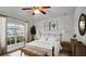Spacious bedroom with large window, neutral decor, and a comfortable sitting area at 4070 Island Lakes Dr, Winter Haven, FL 33881