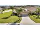 Tan one-story house with palm trees and a two-car garage at 4070 Island Lakes Dr, Winter Haven, FL 33881
