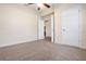 Simple bedroom with carpet, neutral walls, and doors leading to another room at 4070 Island Lakes Dr, Winter Haven, FL 33881