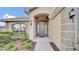 Inviting exterior with a covered entryway and well-manicured landscaping at 4070 Island Lakes Dr, Winter Haven, FL 33881