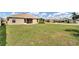 Large backyard with grassy lawn and partial fence at 4070 Island Lakes Dr, Winter Haven, FL 33881