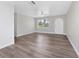 Bright and airy living room with vinyl plank flooring and brick accent wall at 5400 Fox Briar Trl, Orlando, FL 32808