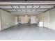 Attached garage with open door and gray floor at 5400 Fox Briar Trl, Orlando, FL 32808