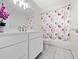 Bathroom with white vanity, floral shower curtain, and tile floor at 5400 Fox Briar Trl, Orlando, FL 32808