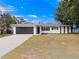 Newly renovated home with a modern facade and spacious driveway at 5400 Fox Briar Trl, Orlando, FL 32808