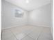 Bright bedroom with tile floors and a window at 5400 Fox Briar Trl, Orlando, FL 32808