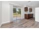 Kitchen with dark brown cabinets, vinyl flooring, and sliding glass doors to backyard at 5400 Fox Briar Trl, Orlando, FL 32808