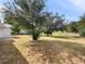 Large backyard with mature trees and grassy area at 5400 Fox Briar Trl, Orlando, FL 32808