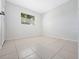 Simple bedroom with tile floors and a window at 5400 Fox Briar Trl, Orlando, FL 32808