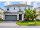 Two-story house with gray garage door and palm trees at 2621 Calistoga Ave, Kissimmee, FL 34741
