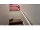Modern carpeted staircase with a contemporary art piece at 2621 Calistoga Ave, Kissimmee, FL 34741