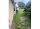 Side yard with mature trees and grass at 1278 Snug Harbor Dr, Casselberry, FL 32707