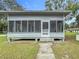 Quaint house with a screened porch at 1017 Mabbette St, Kissimmee, FL 34741