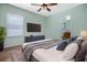 Comfortable bedroom with a queen-size bed and built-in TV at 14177 Avenue Of The Grvs, Winter Garden, FL 34787