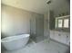 Bathroom with white vanity, soaking tub, and walk-in shower at 3287 Roseville Dr, Apopka, FL 32712