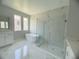 Spa-like bathroom with a soaking tub, walk-in shower, and marble tile at 3287 Roseville Dr, Apopka, FL 32712