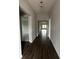 Long entryway with dark hardwood floors at 3287 Roseville Dr, Apopka, FL 32712