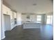 Modern kitchen with white cabinets, a large island, and gray flooring at 3287 Roseville Dr, Apopka, FL 32712