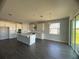 Modern kitchen with white cabinets, a large island, and gray flooring at 3287 Roseville Dr, Apopka, FL 32712