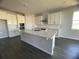 Modern kitchen with white cabinets, island, and stainless steel appliances at 3287 Roseville Dr, Apopka, FL 32712