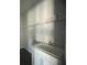 Laundry room with a utility sink and shelving at 3287 Roseville Dr, Apopka, FL 32712