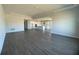 Spacious living room with dark gray tile floors and views into the kitchen at 3287 Roseville Dr, Apopka, FL 32712