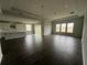 Spacious living room with dark gray tile floors and views into the kitchen at 3287 Roseville Dr, Apopka, FL 32712