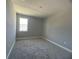 Bright bedroom featuring neutral walls and carpet at 3295 Roseville Dr, Apopka, FL 32712