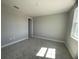 Spacious bedroom with window and neutral decor at 3295 Roseville Dr, Apopka, FL 32712