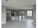 Open concept kitchen with white cabinets, island, and tile floors at 3295 Roseville Dr, Apopka, FL 32712