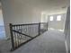 Upstairs hallway with carpet and metal railing at 3295 Roseville Dr, Apopka, FL 32712