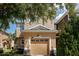 Two-story townhome with a beige exterior and attached garage at 3179 Rodrick Cir, Orlando, FL 32824