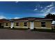 Front view of three-unit building with yellow exterior and tile roofs at 1652 Cumin Dr, Poinciana, FL 34759