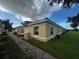 Tan house with a red tile roof, white trim, and a brick walkway at 1652 Cumin Dr, Poinciana, FL 34759