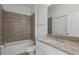 Bathroom with gray tile shower and granite countertop vanity at 1652 Cumin Dr, Poinciana, FL 34759