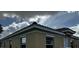 Tan house with a red tile roof, white trim, and a brick walkway at 1652 Cumin Dr, Poinciana, FL 34759